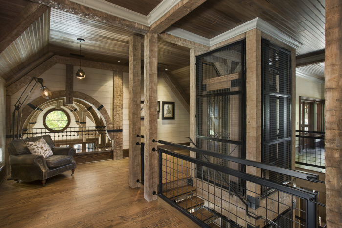 Interior, horizontal, upper level loft looking into living room with elevator to right, Bowden residence, Balsam Mountain Preserve, North Carolina; M. Shawn Leatherwood & Associates; Morgan Keefe Builders