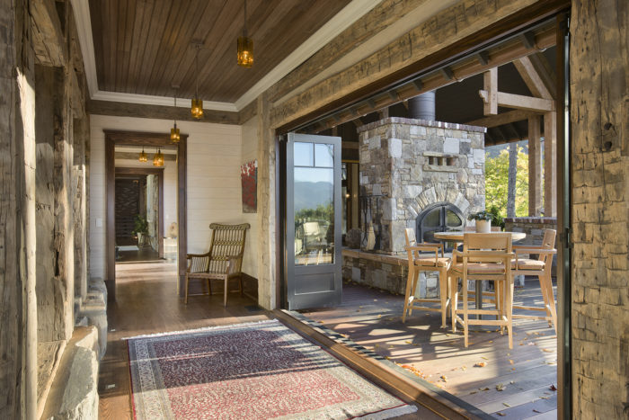 Interior, horizontal, hallway looking out to covered patio, Bowden residence, Balsam Mountain Preserve, North Carolina; M. Shawn Leatherwood & Associates; Morgan Keefe Builders