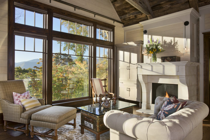 Interior, horizontal, master bedroom sitting area looking out to mountain view in fall color, Bowden residence, Balsam Mountain Preserve, North Carolina; M. Shawn Leatherwood & Associates; Morgan Keefe Builders