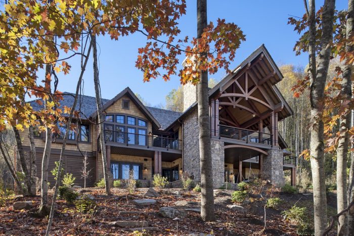 Exterior, horizontal, rear 3/4 view through trees in fall color, Lemonine residence, Balsam Mountain Preserve, North Carolina; M. Shawn Leatherwood & Associates; Morgan-Keefe Builders
