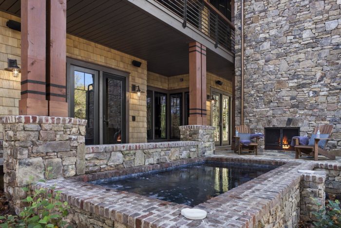 Exterior, horizontal, built in hot tub looking toward fireplace patio and deck, Lemonine residence, Balsam Mountain Preserve, North Carolina; M. Shawn Leatherwood & Associates; Morgan-Keefe Builders