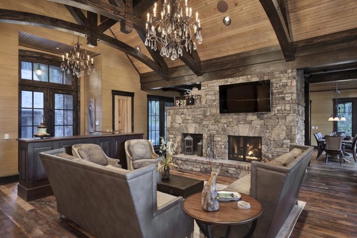 Interior, horizontal, living room toward fireplace and entry at twilight, Lemonine residence, Balsam Mountain Preserve, North Carolina; M. Shawn Leatherwood & Associates; Morgan-Keefe Builders