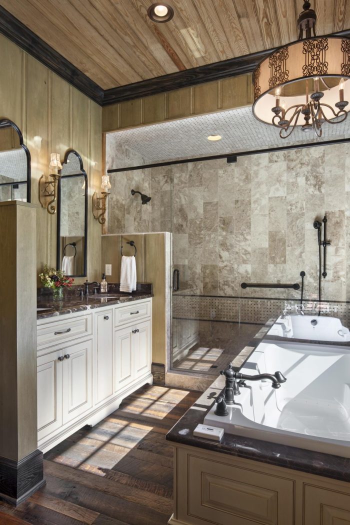 Interior, vertical, guest master bathroom toward tub shower and vanity, Lemonine residence, Balsam Mountain Preserve, North Carolina; M. Shawn Leatherwood & Associates; Morgan-Keefe Builders